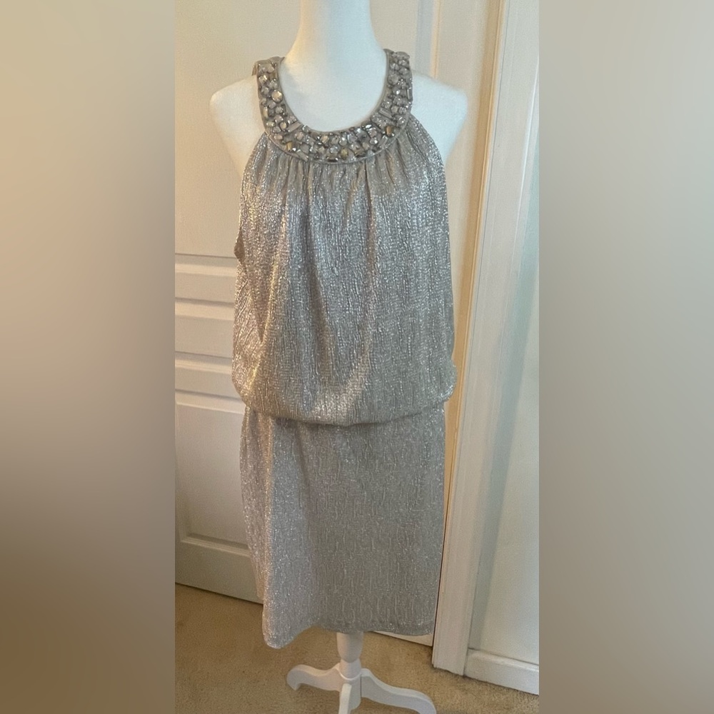 Jackie Jon Dress. Size 12. Silvery shiny dress with jewels on neckline.